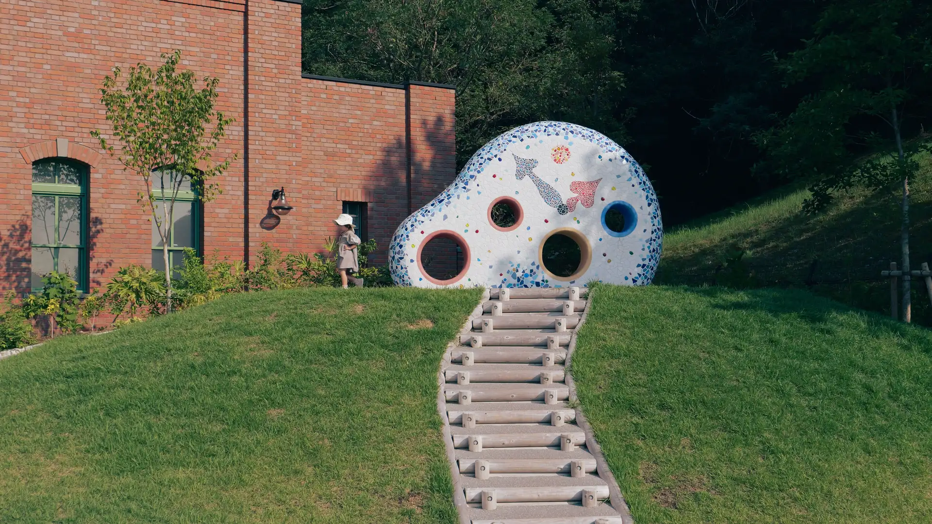 A whimsical sculpture on a green hillside at Ghibli Park, Nagakute, Japan